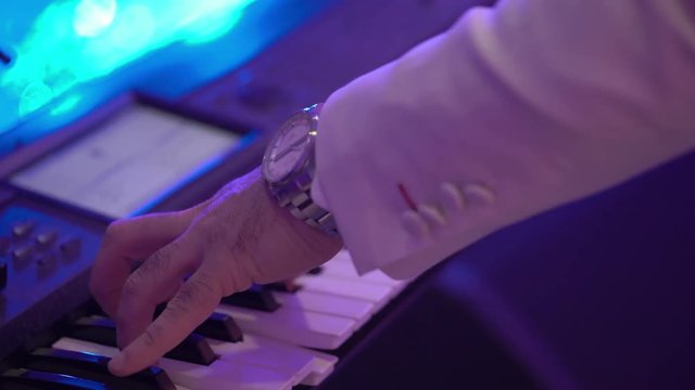 Man playing music on keyboard at concert