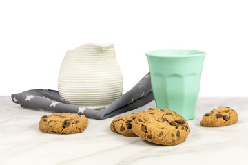 Chocolate chips cookies, glass and jar of milk