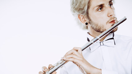 Male flutist playing his flute © anetlanda