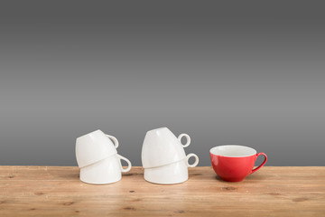 Different coffee cups on the wooden table with grey background