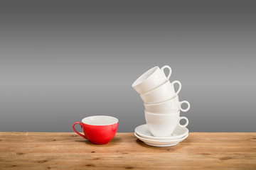 Different coffee cups on the wooden table with grey background