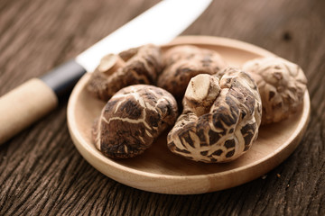 dried shiitake mushroom in wood dish for food background