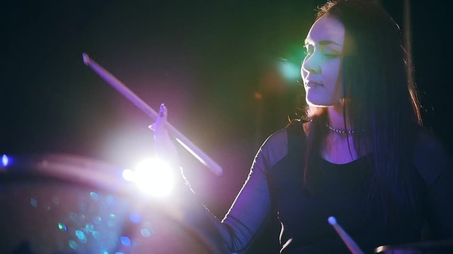Beauty black hair girl twisting drumstick - drum performing, rock music, slow motion