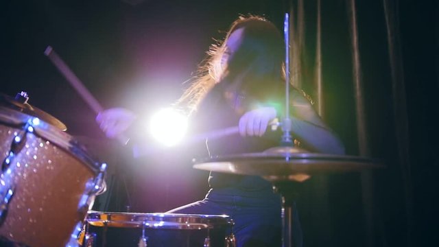 Hard rock music - drum break down performing - attractive girl with flowing hair, slow motion