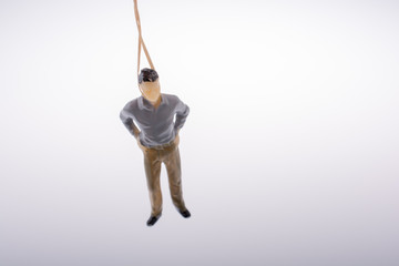 Man  figurine tied  with aa rope