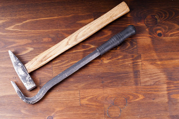 Hammer and nail puller on a table. Old tools