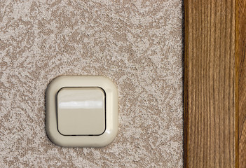 Home beige plastic light switch closeup.