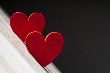 two hearts on dark wooden background