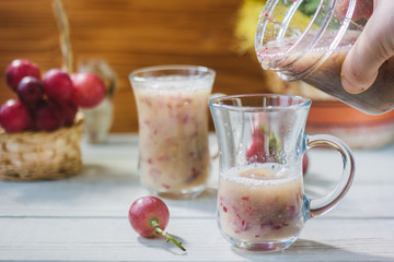 Grape smoothie over the white table.