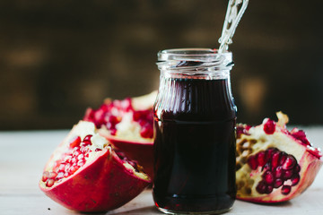 Organic pomegranate sauce on glass bottle with spoon