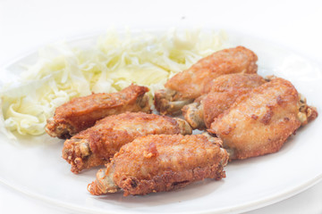 Chicken wings in plate with and cabbage alley.