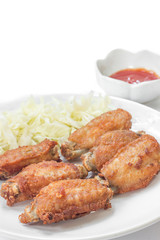 Chicken wings in plate with and cabbage alley.