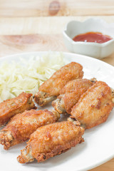 Chicken wings in plate with tomato sauce.