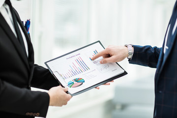 business partners discuss the financial charts of the future contract