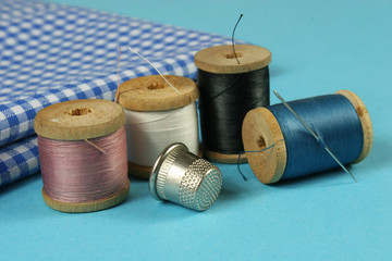 wooden spools with colored cotton threads for sewing, vintage