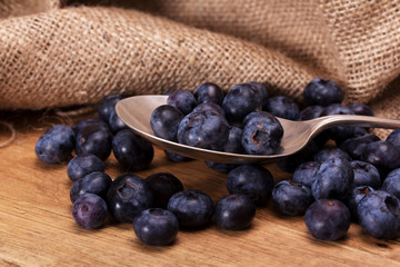 Blueberries and spoon on a rustic background