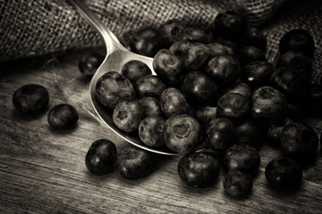 Blueberries and spoon on a rustic background