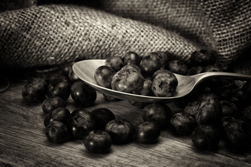 Blueberries and spoon on a rustic background