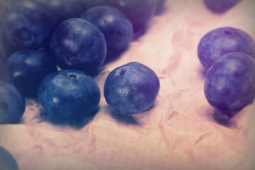 Fototapeta na wymiar Fresh blueberries on a rustic brown paper background