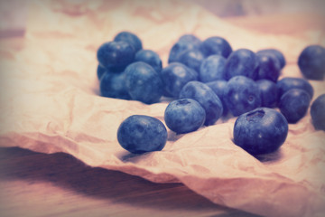Fresh blueberries on a rustic brown paper background