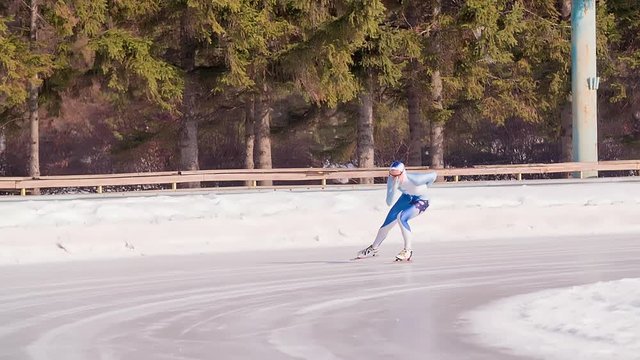 Speed ice skater skating on outdoor race on turn HD slow-motion video. Professional athlete training for winter olympic