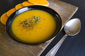 Pumpkin soup on a wooden table