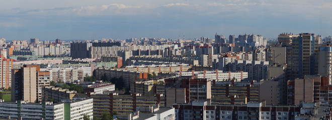 Fototapeta na wymiar Panorama of a city block with high multi-storey apartment buildings, the area of the big city from a height