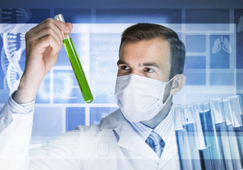 Portrait of concentrated male scientist working with reagents in laboratory