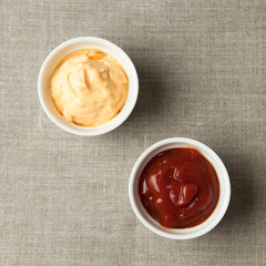 cups with ketchup and cheese on napkin made from canvas