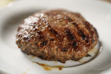 beef cutlets on small white plate, shallow focus