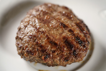 beef cutlets on small white plate, shallow focus