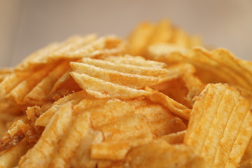 rippled potato chips with paprika closeup photo, shallow focus