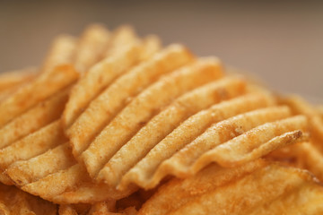 rippled potato chips with paprika closeup photo, shallow focus