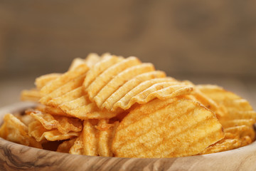 rippled potato chips with paprika closeup photo, shallow focus
