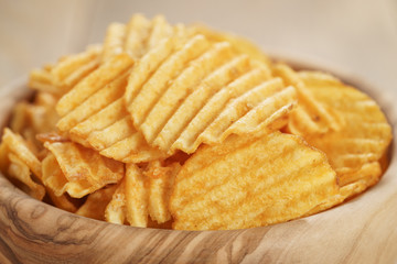 rippled potato chips with paprika closeup photo, shallow focus