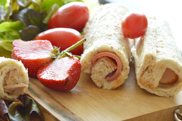 bread roll pork bologna with strawberry and vegetable on wooden cutting board