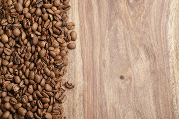 coffee beans on wood background from above, with copy space