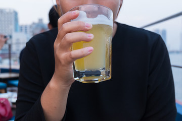 Young asia woman holding fresh beer