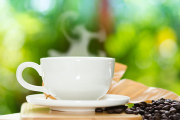 White cup coffee in the garden at moning time.