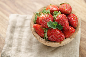fresh strawberries in bowl on napkin on table, organic garden berries
