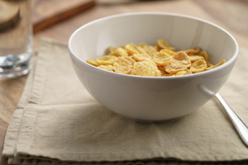 dry corn flakes for breakfast in bowl on table, breakfast preparation