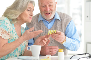 Elderly couple with pills