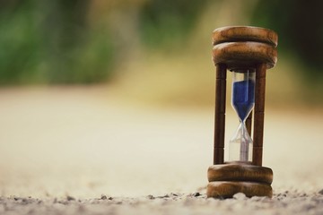 Close up hourglass with copy space wallpaper background, vintage tone
