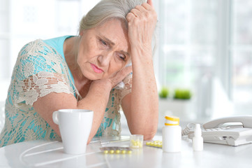 Sick elderly woman with medication