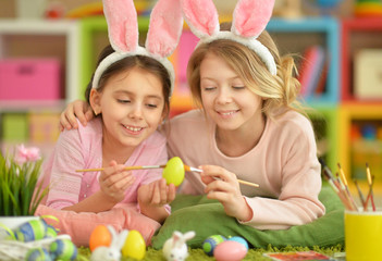 Two cute girls painted Easter eggs