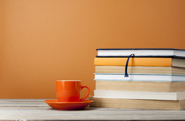 Cup of tea and books on wooden table.Copy space for text.