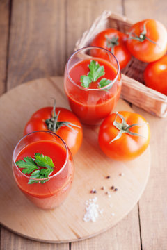Glass of fresh tomato juice and tomatoes 