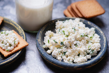 Cracker cookies with cottage cheese and glass of milk