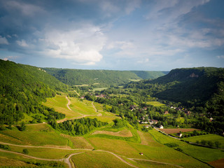 village with wine fields against green mountains