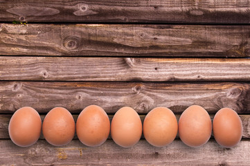 Line of eggs on wooden planks, easter background